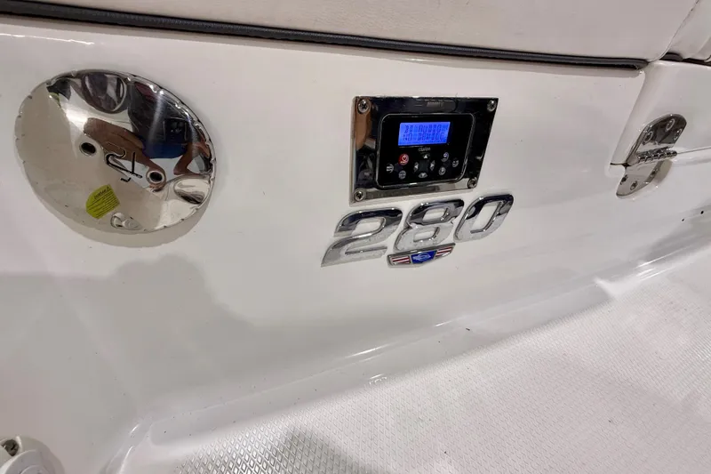 Slide: The Image of 2021 Chaparral 280 OSX boat dashboard with control panel and model emblem. - 19