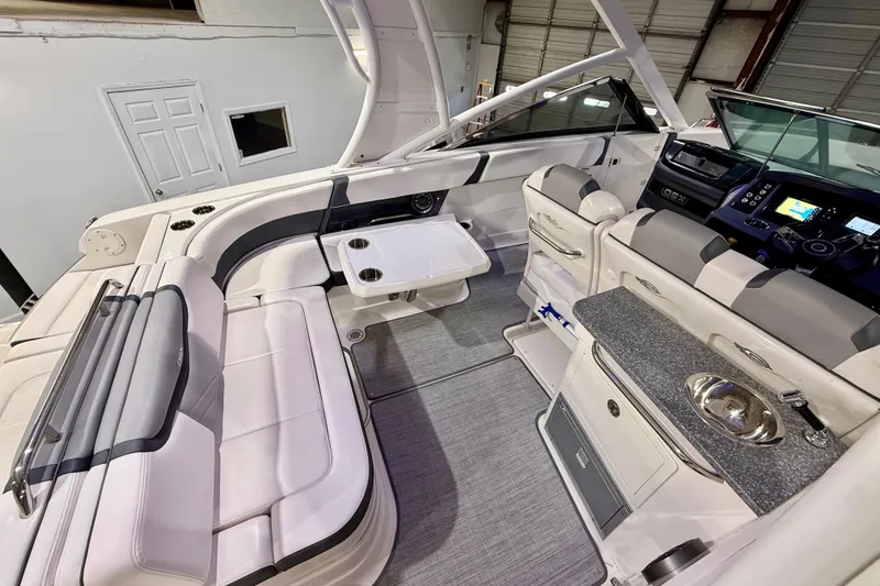 Slide: The Image of Interior of 2021 Chaparral 280 OSX boat with seating, table, and helm. - 21