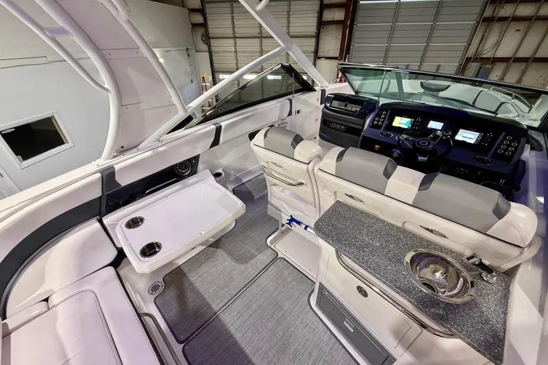 Slide: The Image of 2021 Chaparral 280 OSX boat interior with modern dashboard, seating, and amenities. - 25