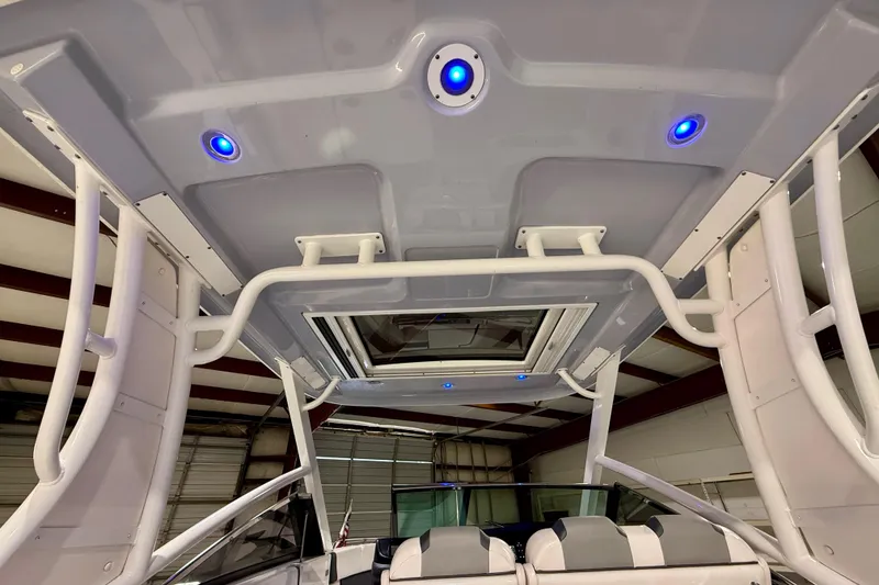 Slide: The Image of 2021 Chaparral 280 OSX boat interior with blue LED lights and modern design. - 26