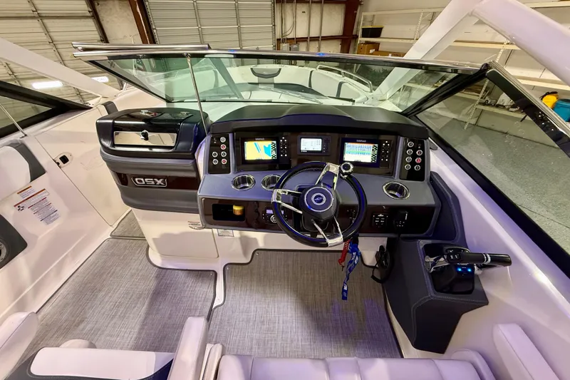 Slide: The Image of 2021 Chaparral 280 OSX boat cockpit with modern controls and navigation displays. - 32