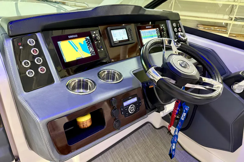 Slide: The Image of Dashboard of 2021 Chaparral 280 OSX boat with navigation screens and steering wheel. - 33