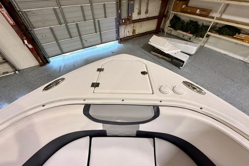 Slide: The Image of 2021 Chaparral 280 OSX boat interior in a garage setting. - 38