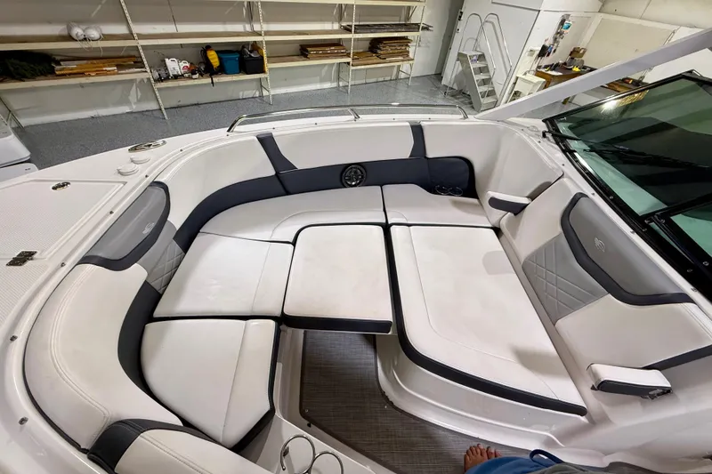 Slide: The Image of Luxurious seating area on a 2021 Chaparral 280 OSX boat, featuring elegant white upholstery. - 40