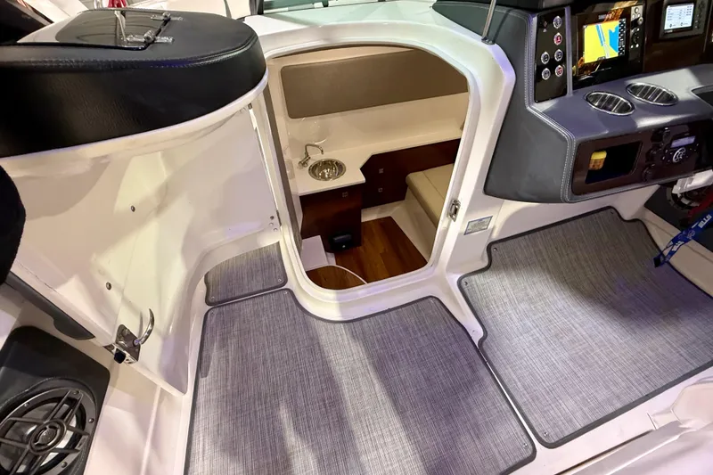 Slide: The Image of Interior view of 2021 Chaparral 280 OSX boat cabin with dashboard and seating area. - 41