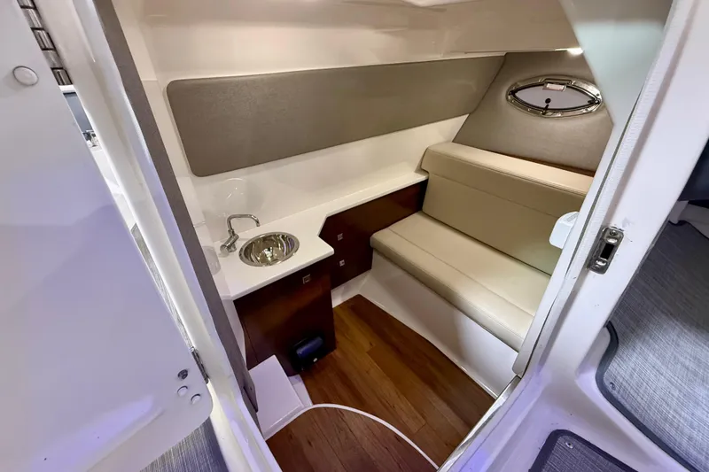Slide: The Image of 2021 Chaparral 280 OSX cabin interior with seating and sink. - 42