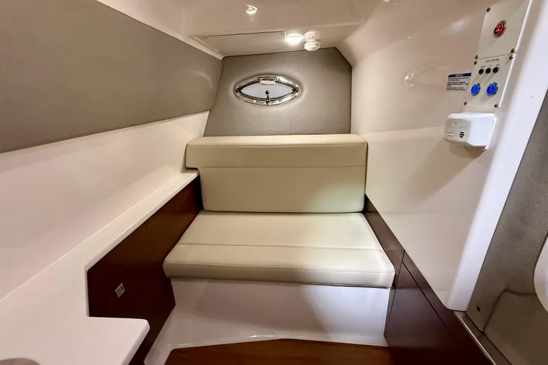 Slide: The Image of 2021 Chaparral 280 OSX cabin interior with beige seating and modern design. - 44