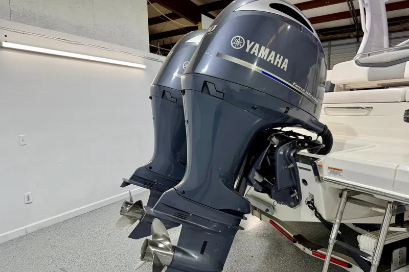 Slide: The Image of 2021 Chaparral 280 OSX with dual Yamaha outboard engines in a showroom setting. - 5
