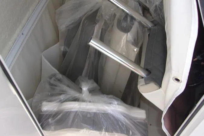 Slide: The Image of 2025 Key West 219 FS boat interior with protective plastic covering. - 2