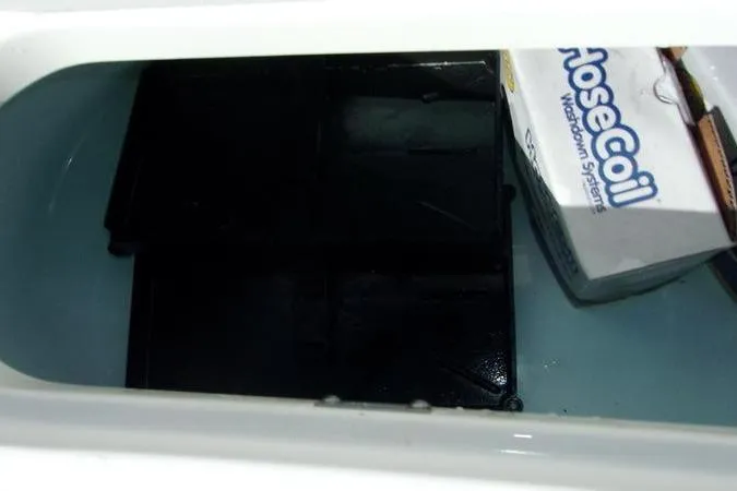 Slide: The Image of Key West 219 FS 2025 boat compartment with RoseCoil washdown system. - 5