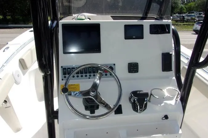 Slide: The Image of 2025 Key West 219 FS boat dashboard with steering wheel and control panel. - 7