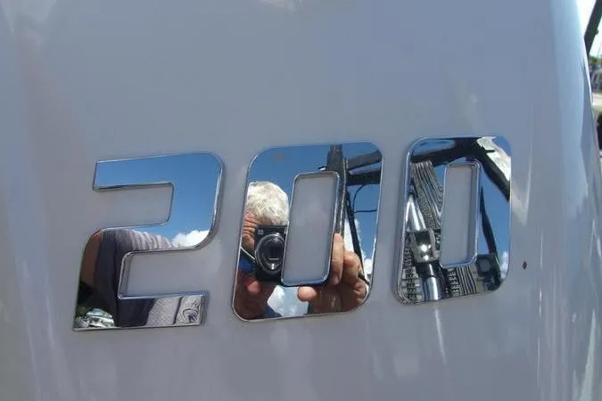Slide: The Image of Reflection on shiny "200" emblem of 2025 Key West 219 FS boat. - 9