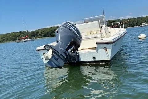 Slide: The Image of 1989 Mako 191CC boat with Yamaha outboard motor on calm water. - 2