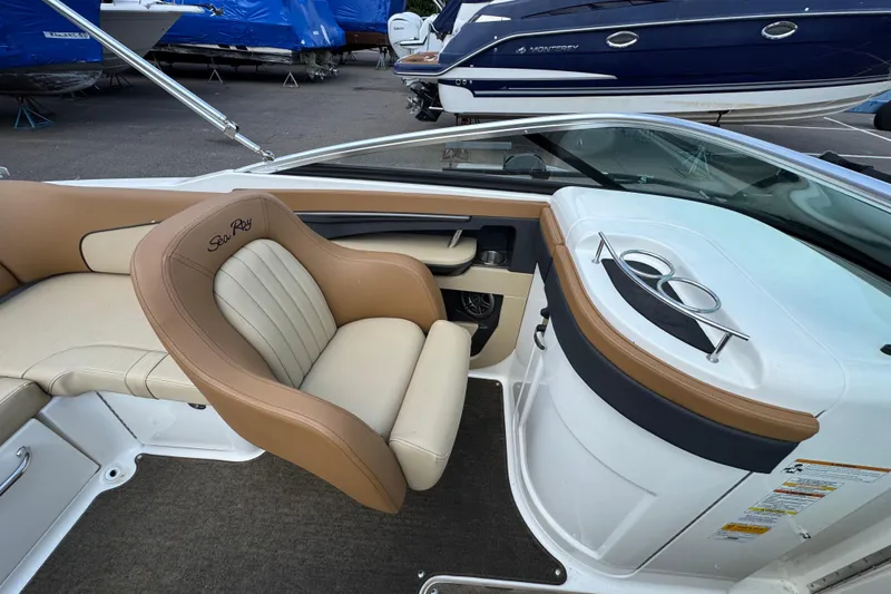 Slide: The Image of 2014 Sea Ray 220 Sundeck Outboard interior with tan seating and cup holders. - 13