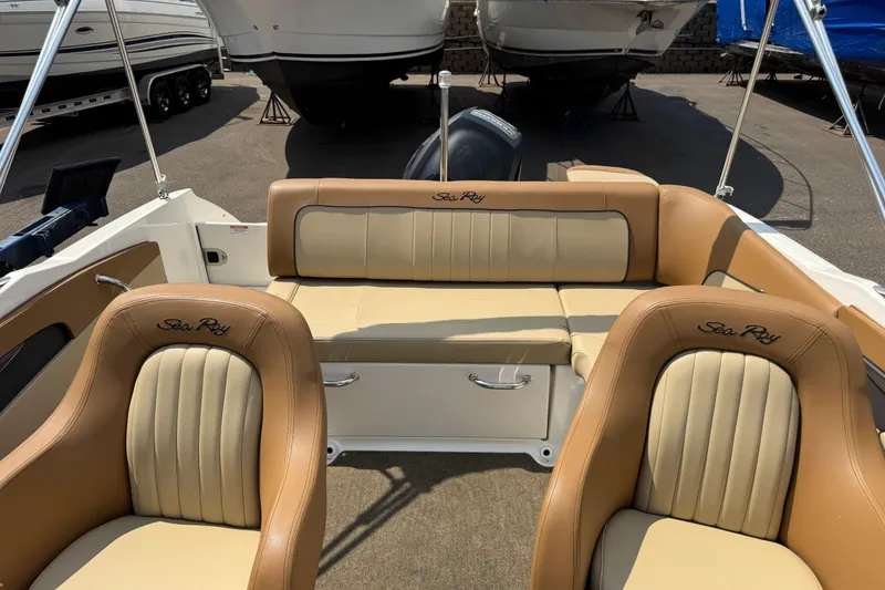 Slide: The Image of 2014 Sea Ray 220 Sundeck Outboard interior with tan leather seating and logo embroidery. - 20