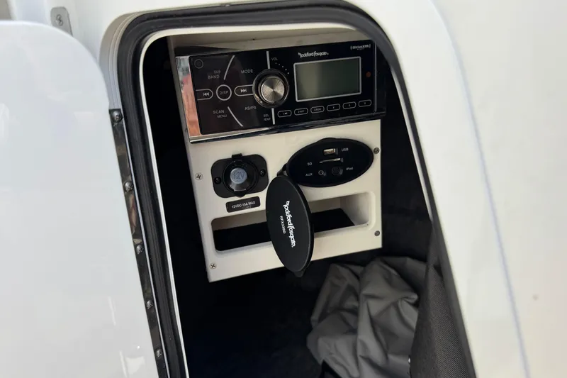 Slide: The Image of 2014 Sea Ray 220 Sundeck Outboard audio system with Rockford Fosgate controls and USB ports. - 22