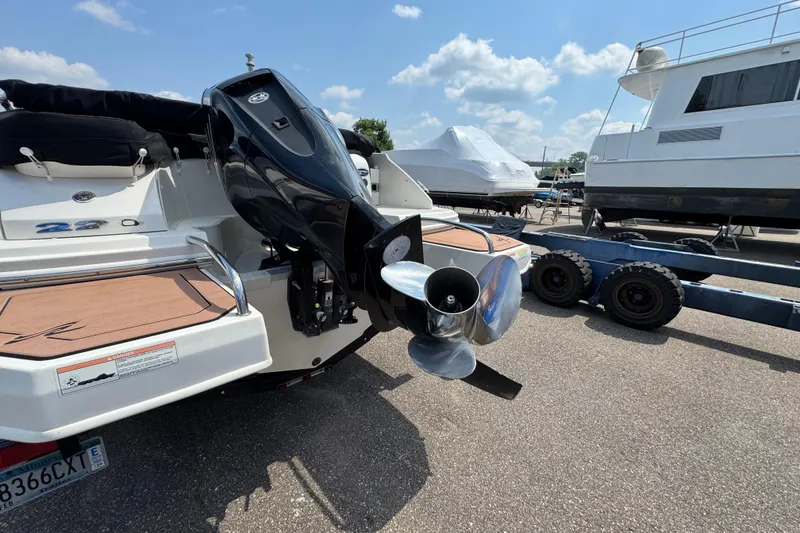 Slide: The Image of 2014 Sea Ray 220 Sundeck Outboard boat with powerful engine, parked on a sunny day. - 5