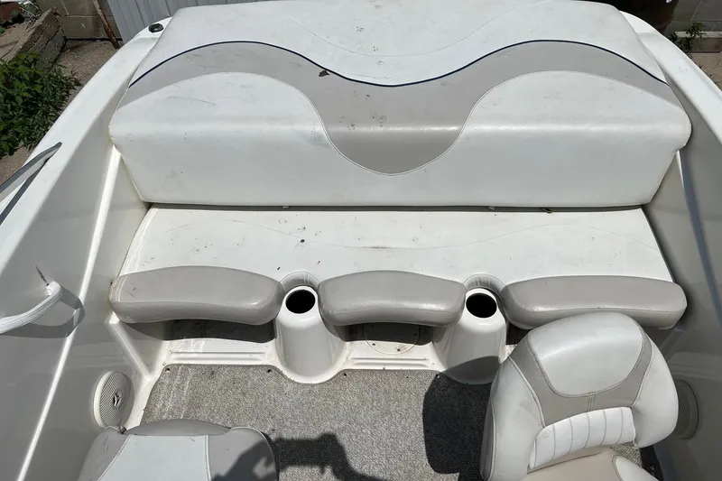 Slide: The Image of 2007 Glastron MX 175 boat interior with white and gray seating and cup holders. - 3