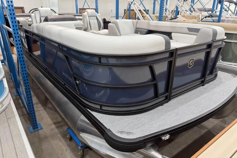Slide: The Image of 2026 Godfrey SWEETWATER 2286 SB pontoon boat in showroom, featuring sleek design and comfortable seating. - 2