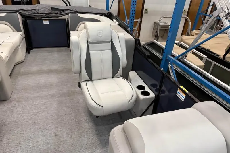 Slide: The Image of 2026 Godfrey SWEETWATER 2286 SB boat interior with plush seating and cup holders. - 5