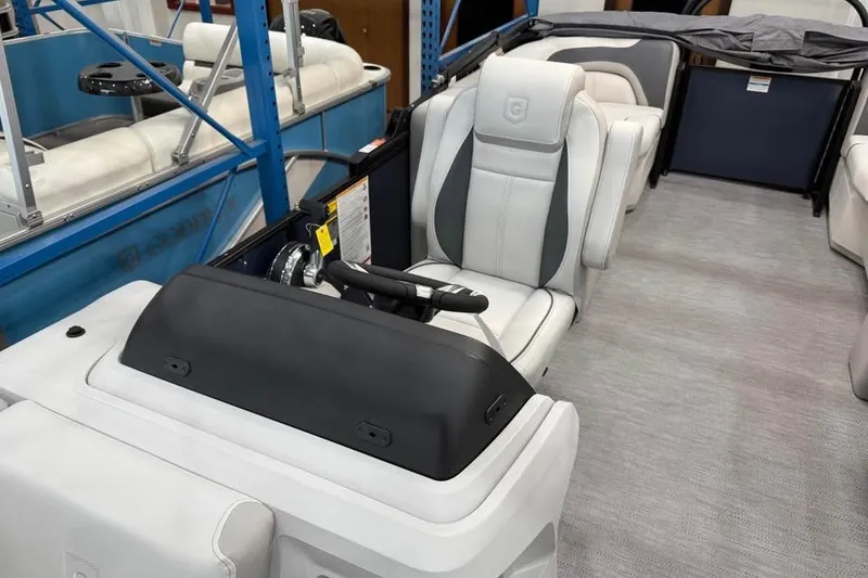 Slide: The Image of 2026 Godfrey SWEETWATER 2286 SB boat interior with modern seating and steering console. - 6