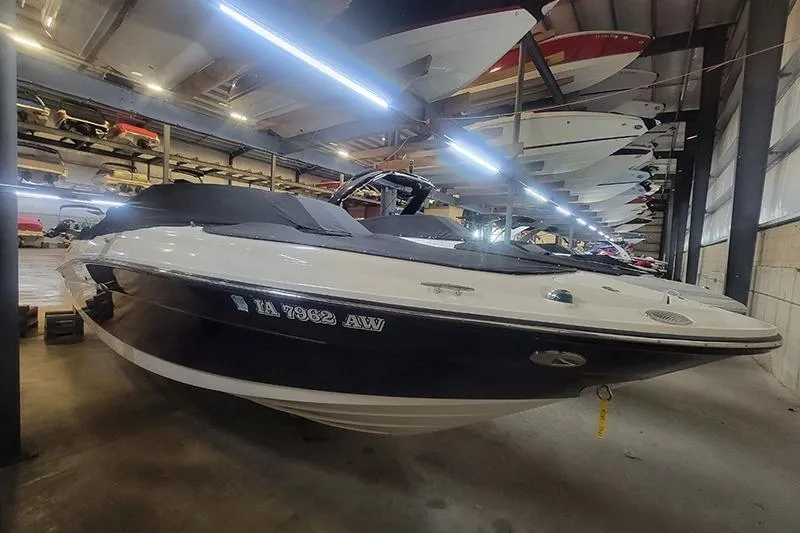 The Image of 2006 Sea Ray 250 SLX boat stored indoors, showcasing sleek design and modern features. - 1