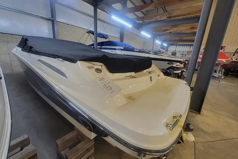 Slide: The Image of 2006 Sea Ray 250 SLX boat in storage, covered and secured indoors. - 3