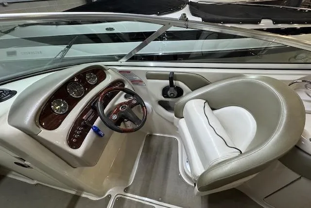 Slide: The Image of Interior view of 2006 Sea Ray SDX 270 boat cockpit with steering wheel and gauges. - 3