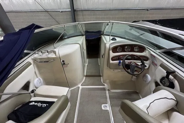 Slide: The Image of 2006 Sea Ray SDX 270 boat interior with steering wheel and seating area. - 4