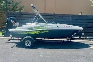 Slide: The Image of 2021 Tahoe T16 boat on trailer, parked outdoors, side view. - 1