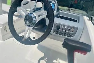 Slide: The Image of 2021 Tahoe T16 boat dashboard with steering wheel and control panel. - 11