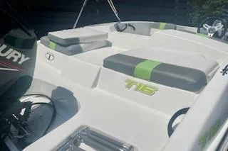 Slide: The Image of 2021 Tahoe T16 boat interior with green-accented seating and Mercury engine. - 3