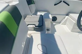 Slide: The Image of 2021 Tahoe T16 boat interior with green-accented seating and steering wheel. - 7