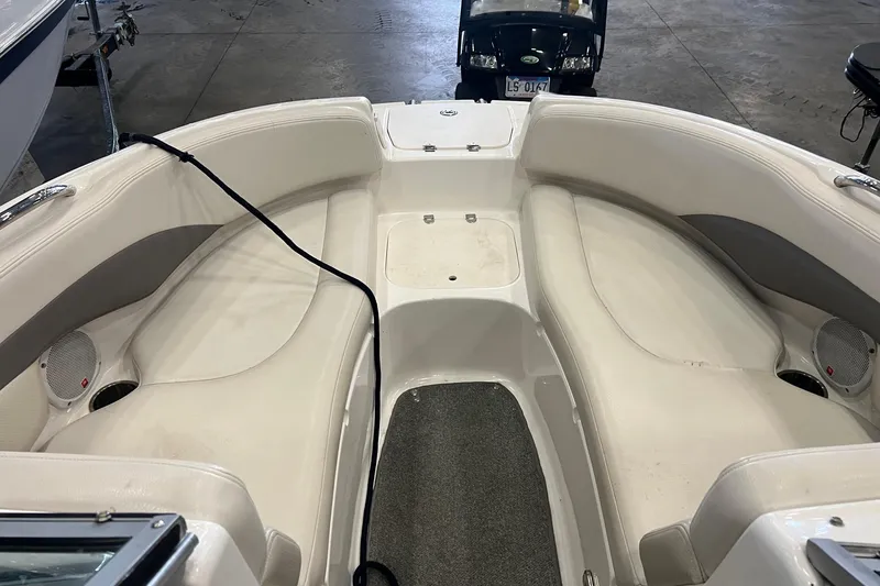 Slide: The Image of 2005 Chaparral 216 SSi boat interior with white seating and speakers. - 3