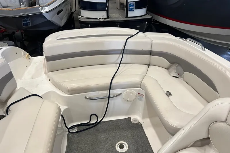 Slide: The Image of 2005 Chaparral 216 SSi boat interior with white seating and gray accents. - 4