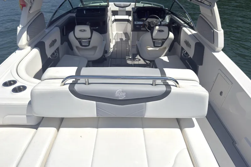 Slide: The Image of 2024 Chaparral 26 Surf boat interior with luxurious seating and modern dashboard. - 6