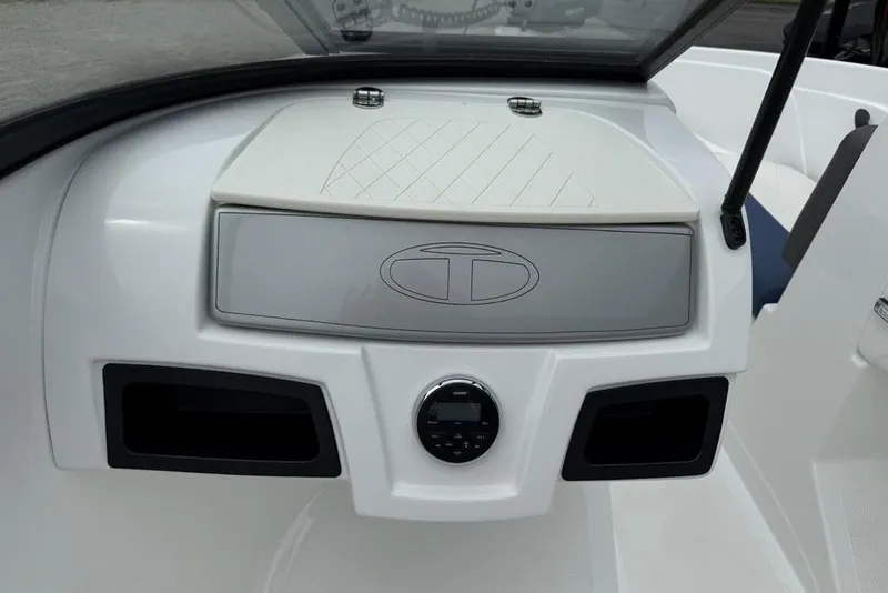 Slide: The Image of 2019 Tahoe 450 TS boat dashboard with storage compartment and control panel. - 13
