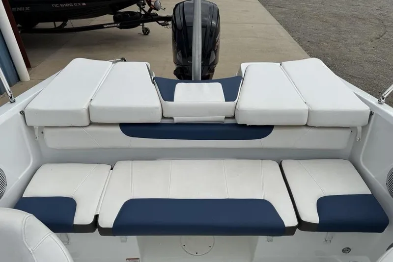 Slide: The Image of 2019 Tahoe 450 TS boat interior with white and blue cushioned seating. - 16