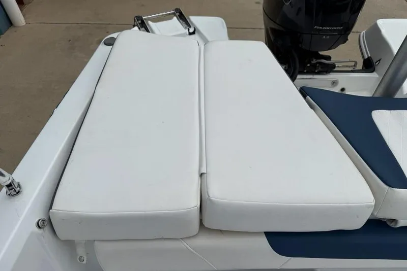 Slide: The Image of 2019 Tahoe 450 TS boat with white cushioned seating and outboard motor. - 22