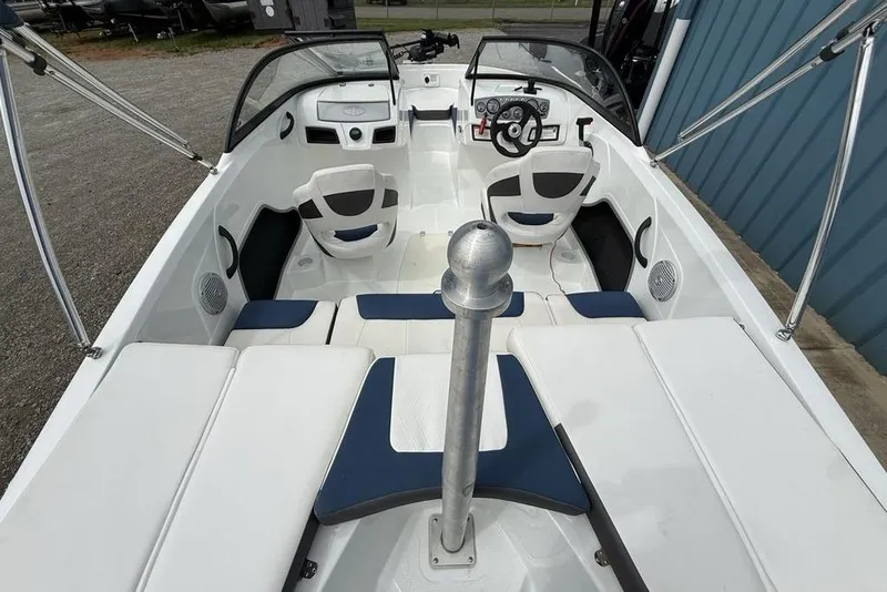 Slide: The Image of 2019 Tahoe 450 TS boat interior with white and blue seating, steering wheel, and dashboard. - 23