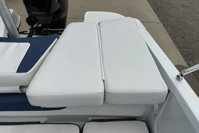 Slide: The Image of 2019 Tahoe 450 TS boat with white cushioned seating and outboard motor. - 24