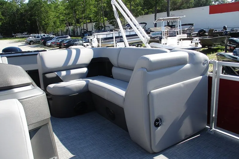 Slide: The Image of 2026 Sun Tracker SportFish 20 DLX pontoon boat with comfortable seating in a marina setting. - 15