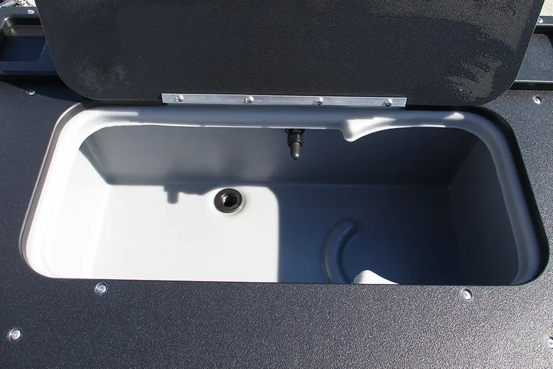 Slide: The Image of Livewell compartment on 2026 Sun Tracker SportFish 20 DLX boat, open lid view. - 25