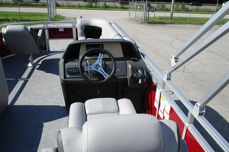 Slide: The Image of 2026 Sun Tracker SportFish 20 DLX pontoon boat interior with steering console and seating. - 27