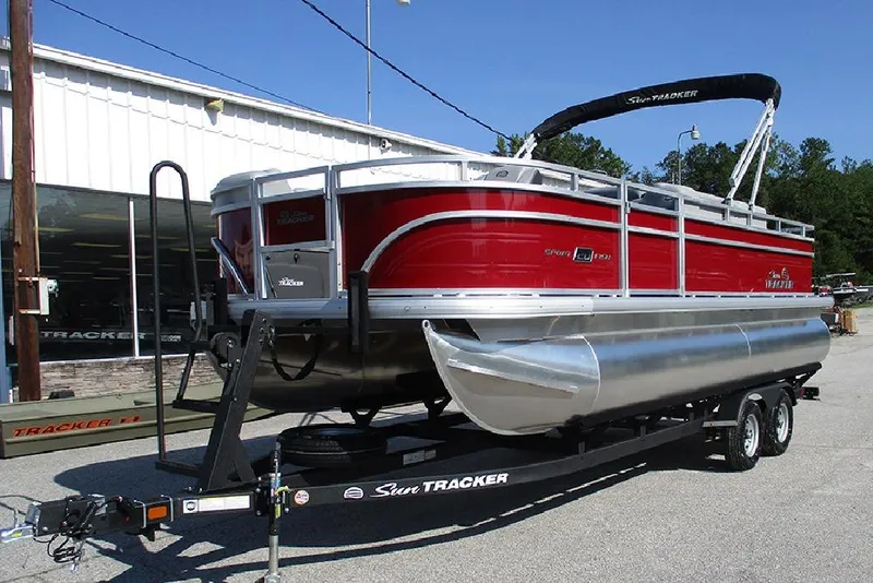 Slide: The Image of 2026 Sun Tracker SportFish 20 DLX pontoon boat on trailer, parked outside dealership. - 3
