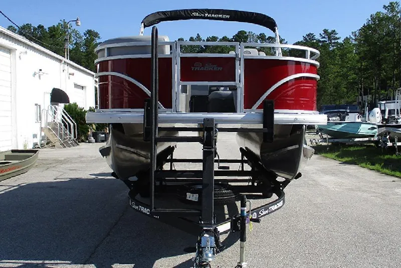 Slide: The Image of 2026 Sun Tracker SportFish 20 DLX pontoon boat on trailer, parked outdoors. - 4