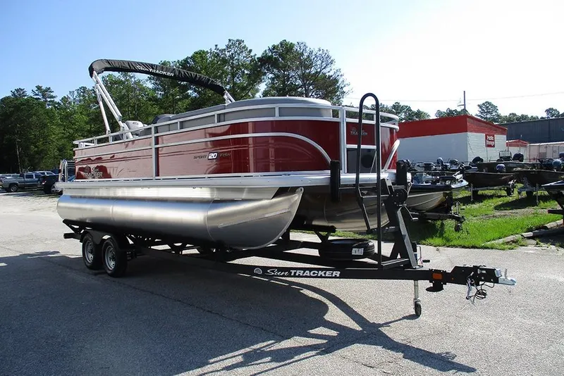 Slide: The Image of 2026 Sun Tracker SportFish 20 DLX pontoon boat on trailer in outdoor setting. - 5