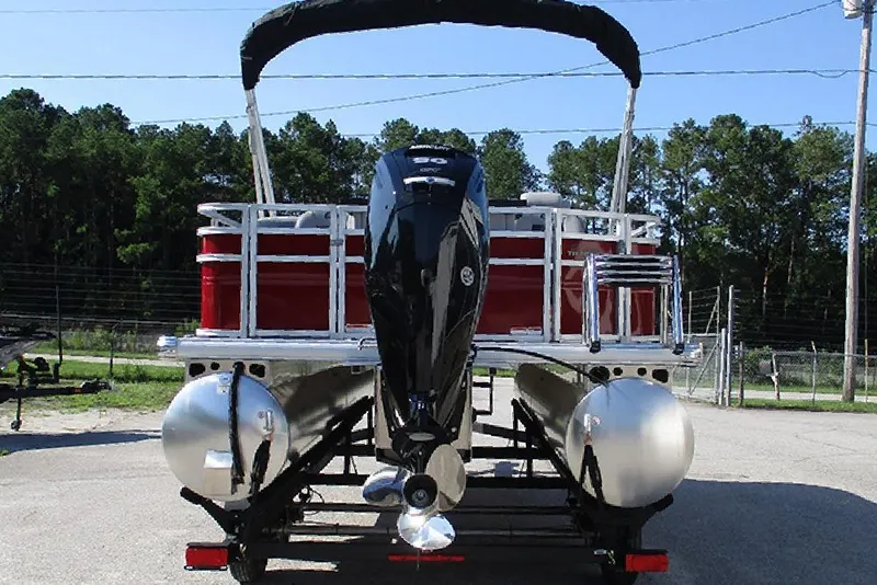 Slide: The Image of 2026 Sun Tracker SportFish 20 DLX pontoon boat with outboard motor, rear view. - 8