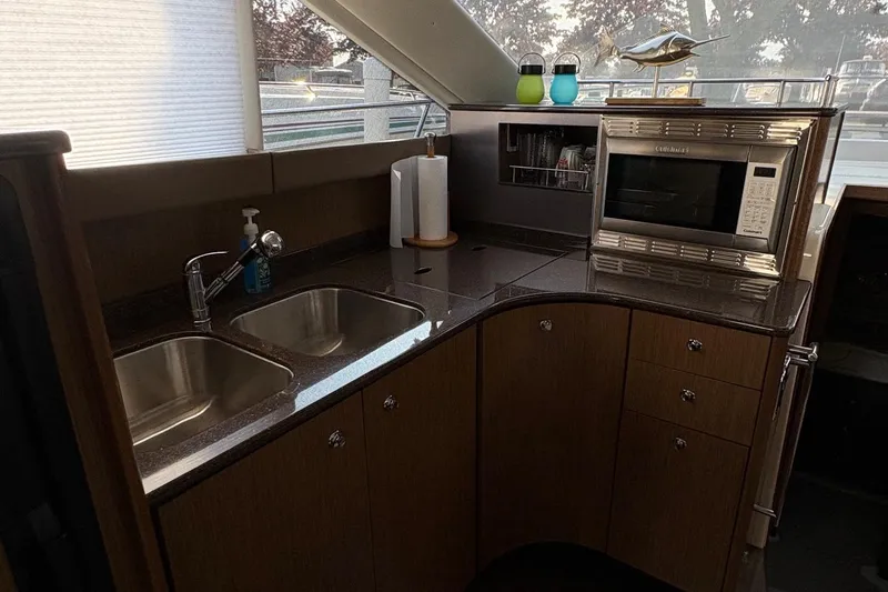 Slide: The Image of 2015 Meridian 441 Sedan kitchen with dual sinks, microwave, and modern cabinetry. - 11