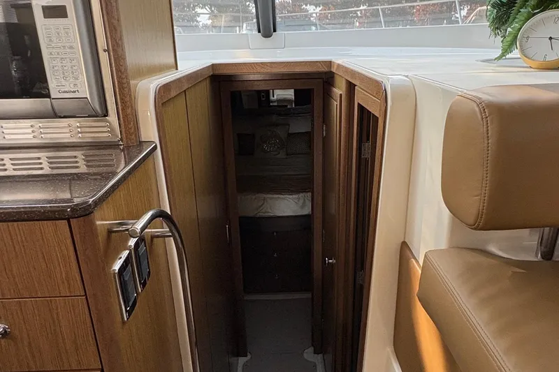 Slide: The Image of Interior of a 2015 Meridian 441 Sedan yacht, featuring a cozy cabin entrance. - 13